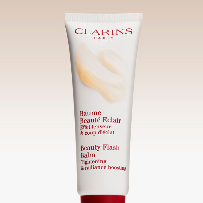 Packshot of Clarins Beauty Flash Balm on a textured background, highlighting its nourishing power for tired skin.