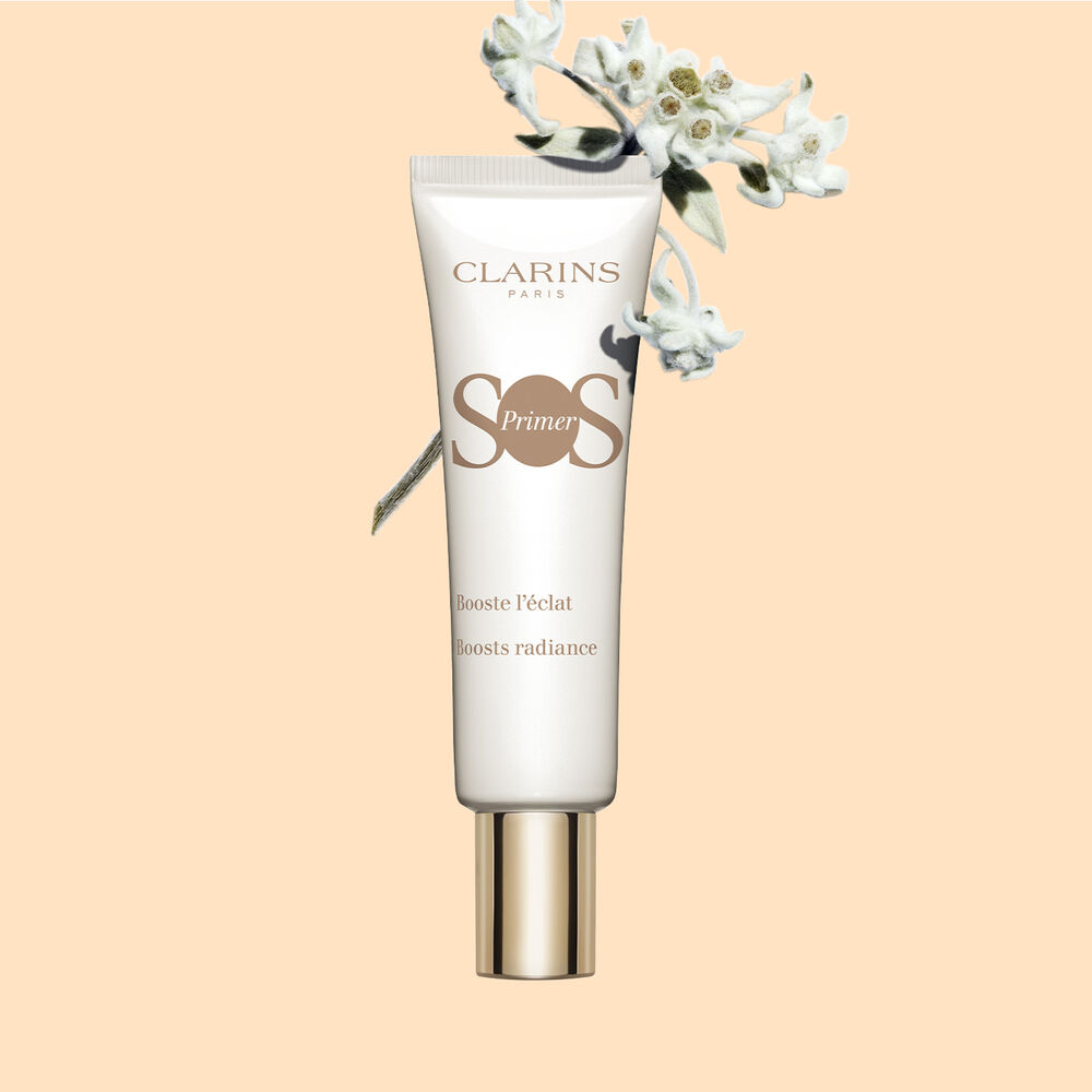 Tube of SOS Primer White by Clarins, featuring edelweiss flowers, to boost glow and increase skin luminosity.
