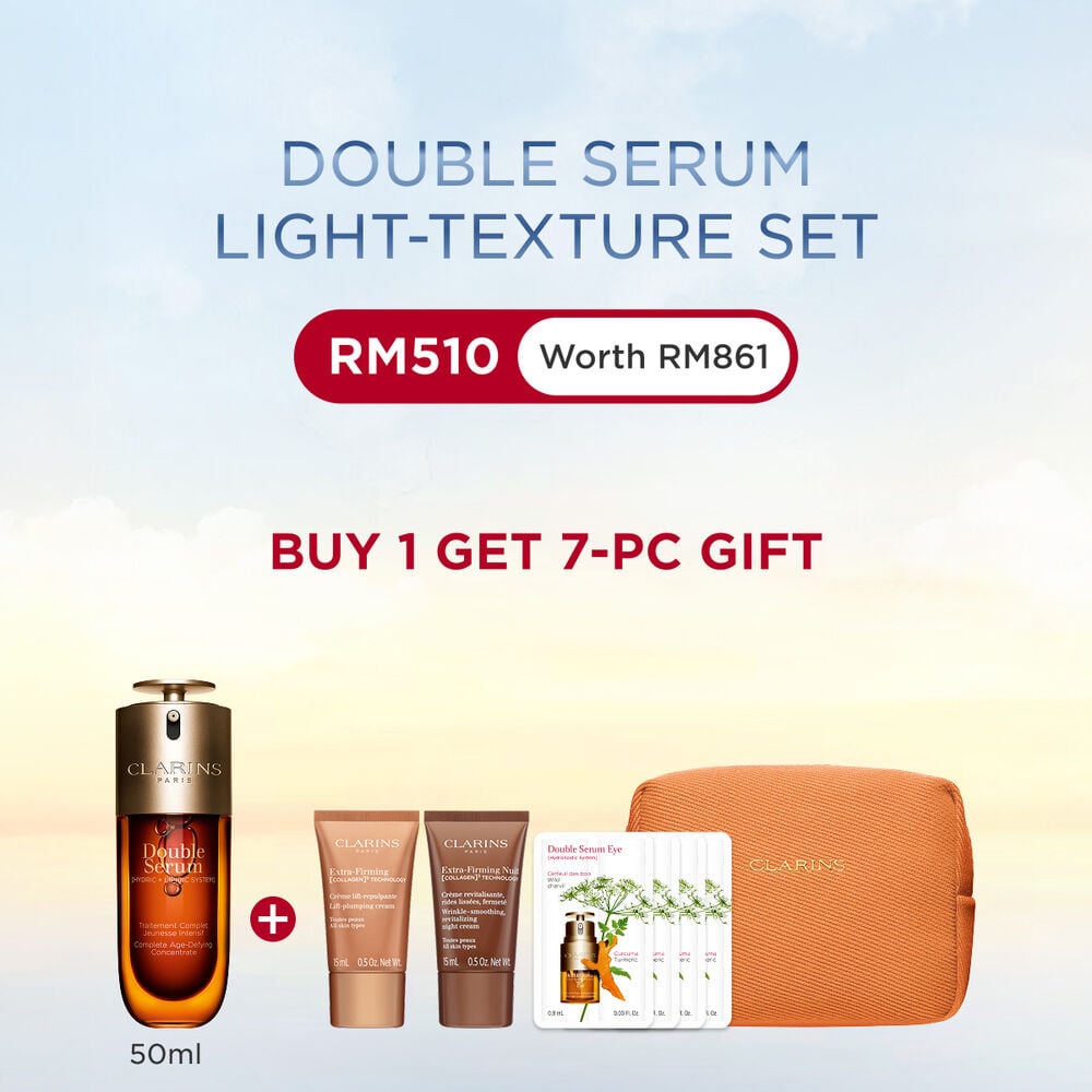 A 50ml bottle of Clarins Double Serum Light Texture among turmeric and provençal reed leaves against an orange background.