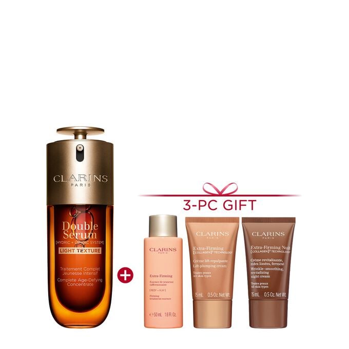 A 50ml bottle of Clarins Double Serum Light Texture among turmeric and provençal reed leaves against an orange background.