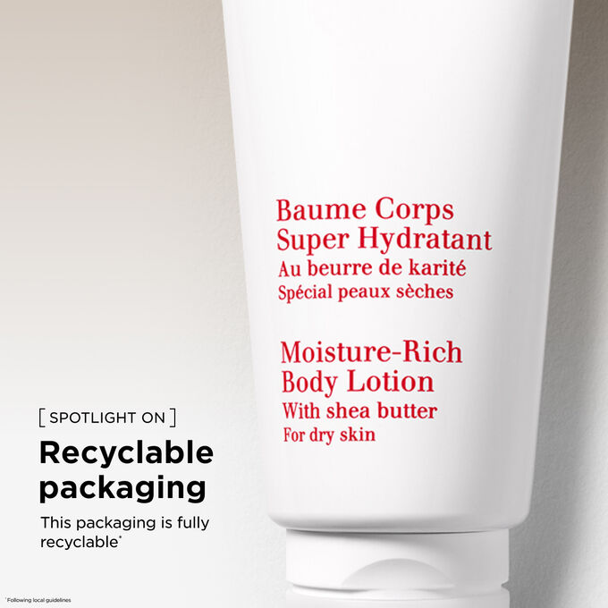 Clarins Moisture-Rich Body Lotion among orange tree leaves and shea nuts to illustrate the natural origin of the ingredients.