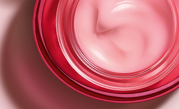Open jar of Rose Radiance Cream shot from above, showing pink-tinted cream inside